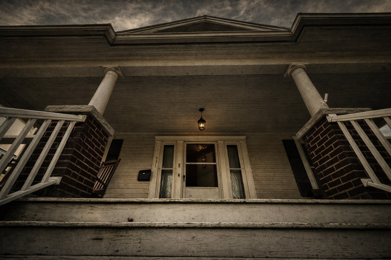 Upward view of the Fears House front porch and columns.